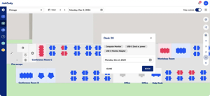AskCody Maps showing the Chicago office floor plan with free desks in blue and booked desks in red, next to Conference Room B, Conference Room C, the Workshop Room and the Help Desk. Desk 20 is selected, showing its computer monitor and USB-C dock, a date picker and a Book button.
